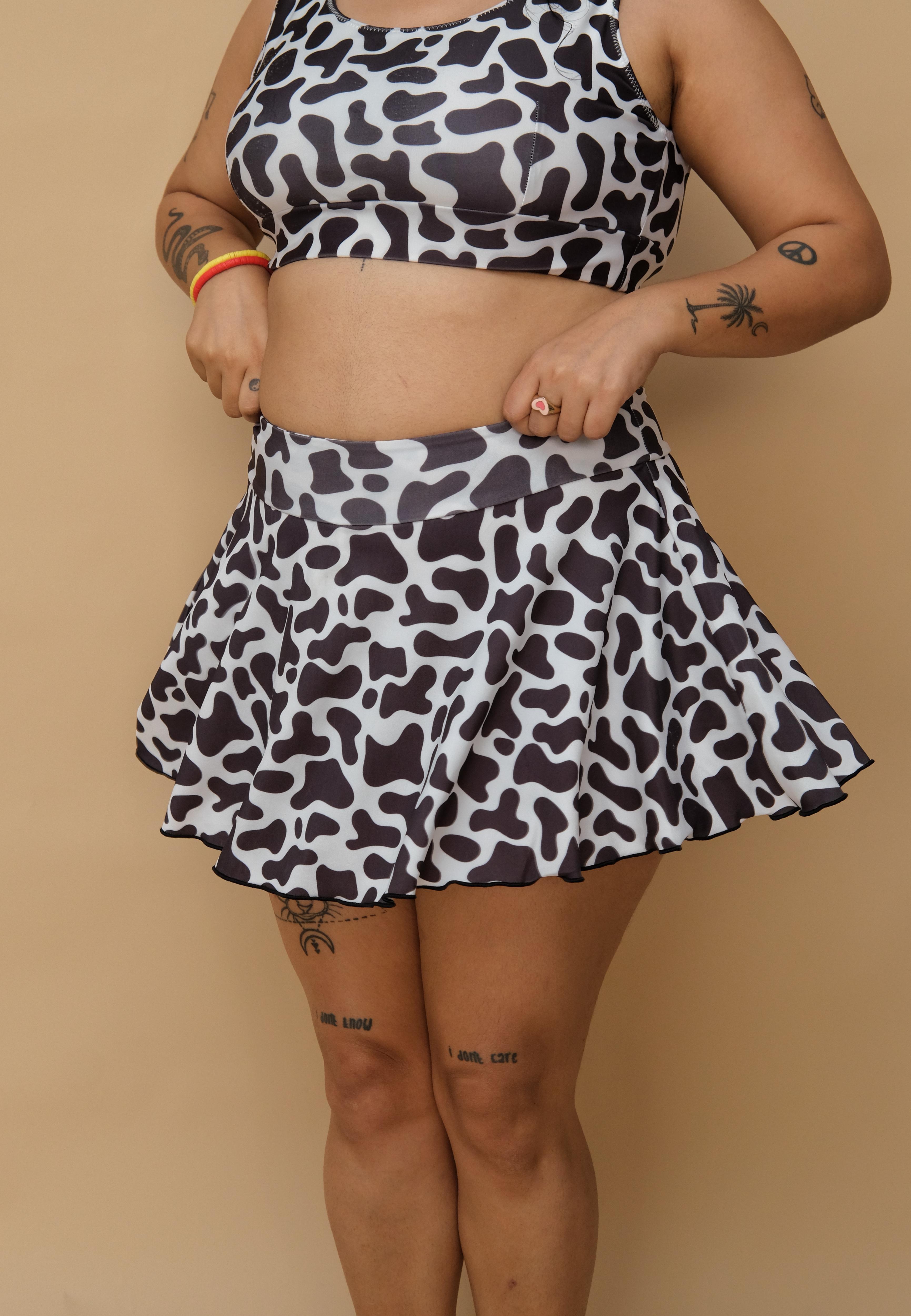 Woman wearing a black and white patterned top and skirt 