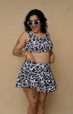 Woman wearing a cow print outfit 