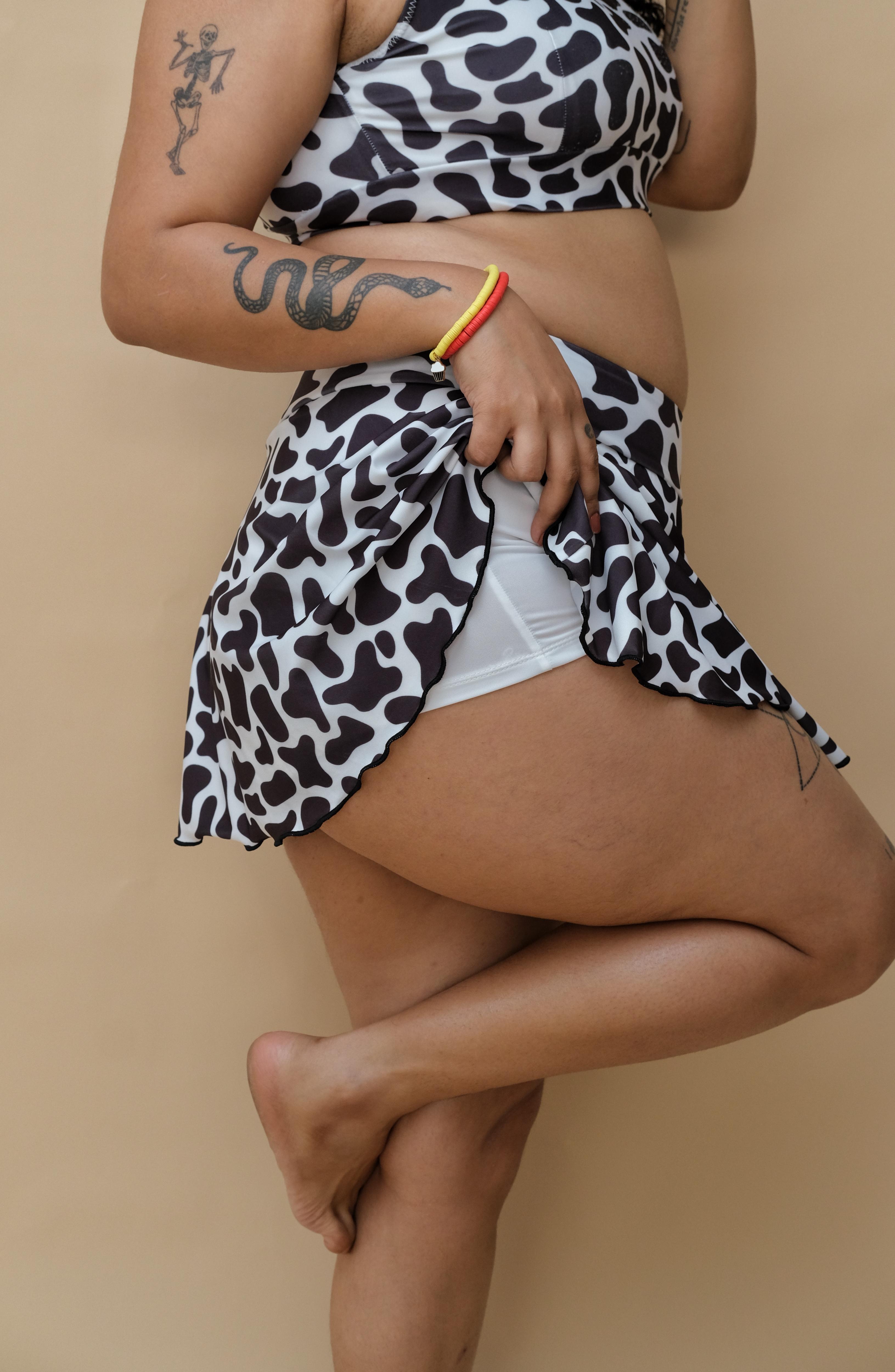 Woman wearing a cow print top and bottom 