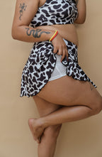 Woman wearing a cow print top and bottom 