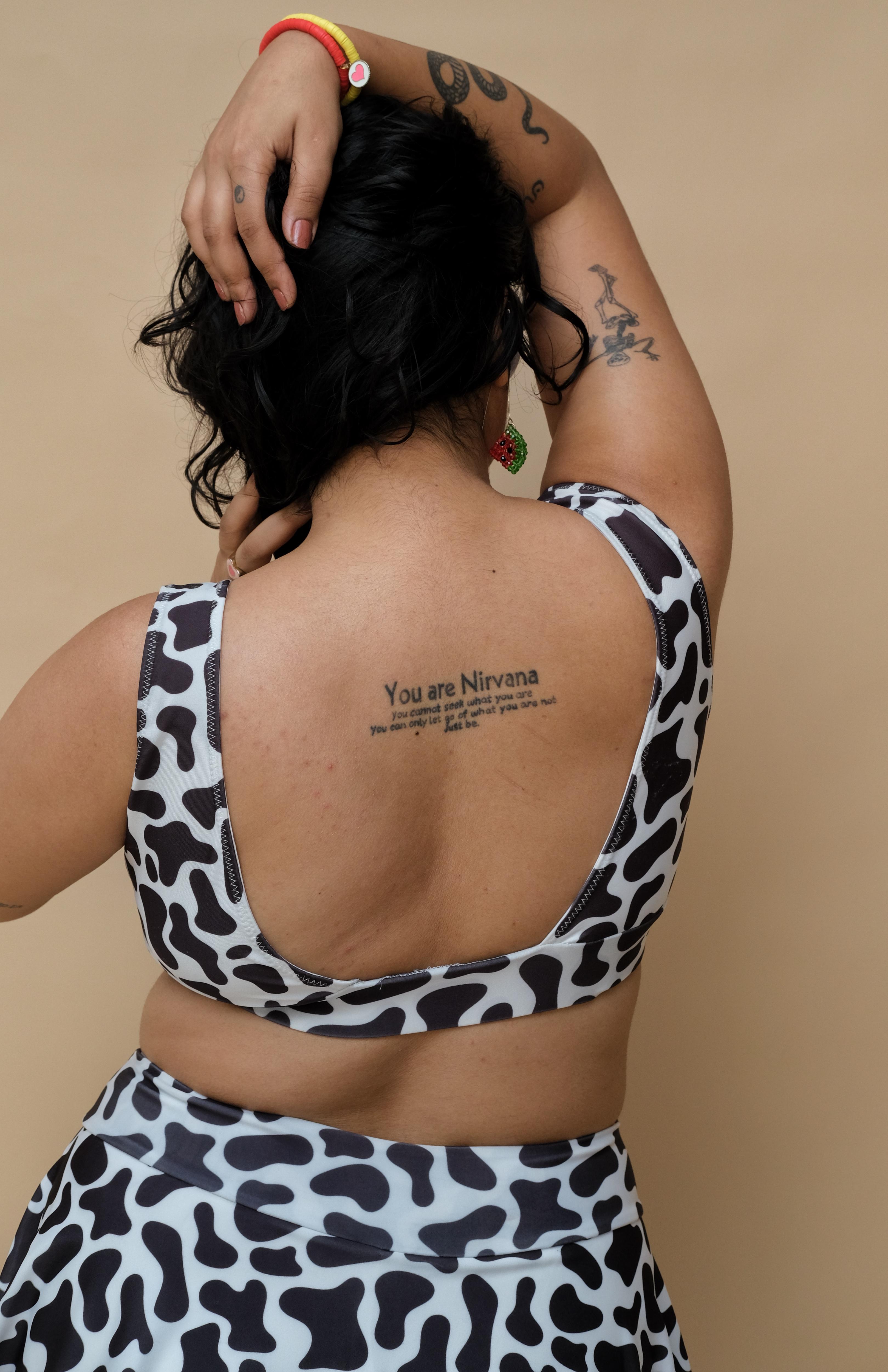 Woman wearing a cow print bikini top