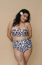 Woman wearing a cow print bikini set 