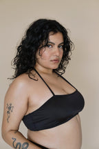 Woman wearing a black halter neck bikini top 