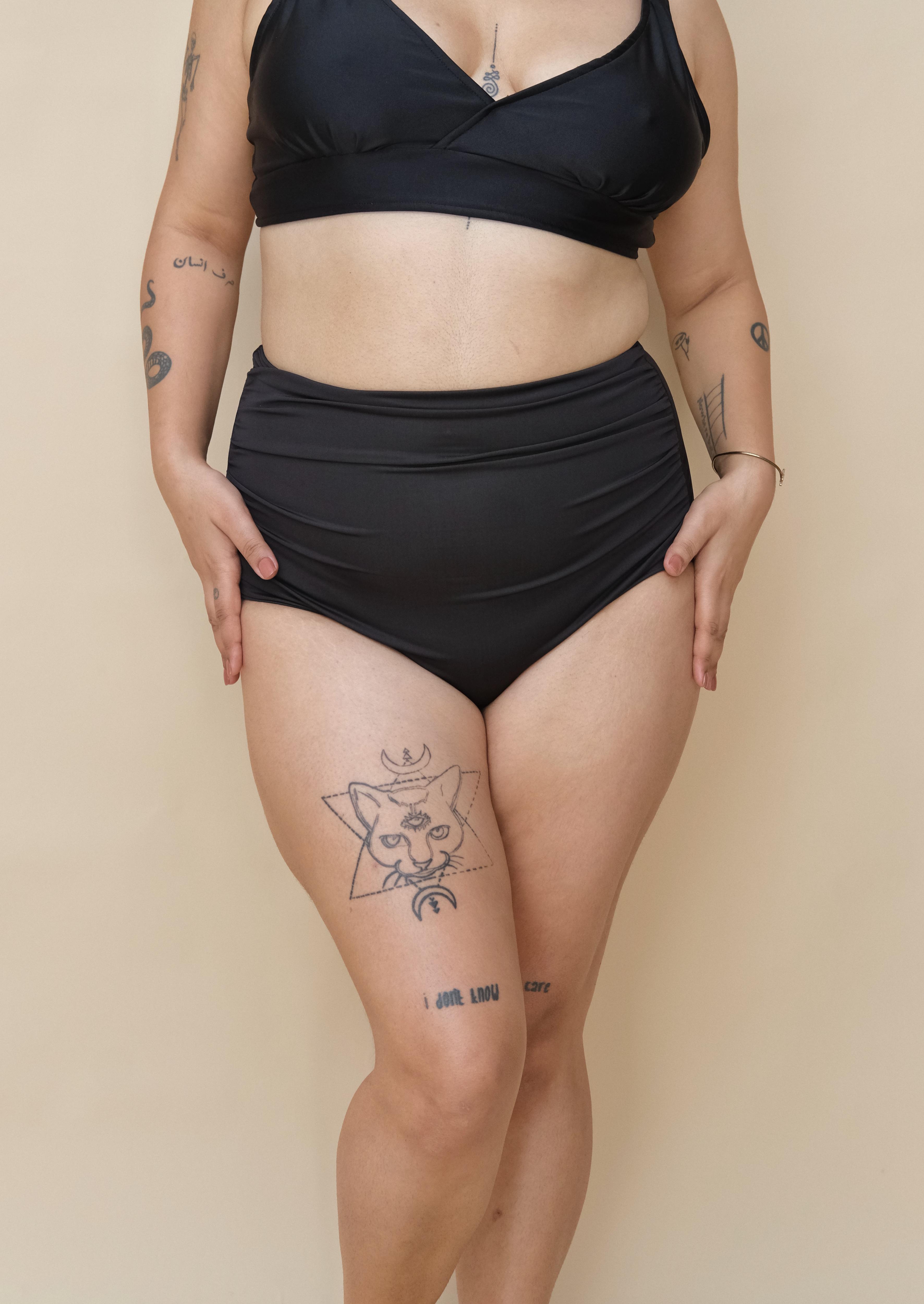 Plus size woman wearing a black bikini 