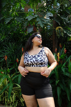 Woman wearing a cow print top and black shorts 