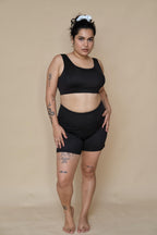 Woman wearing a black bikini top and shorts set 