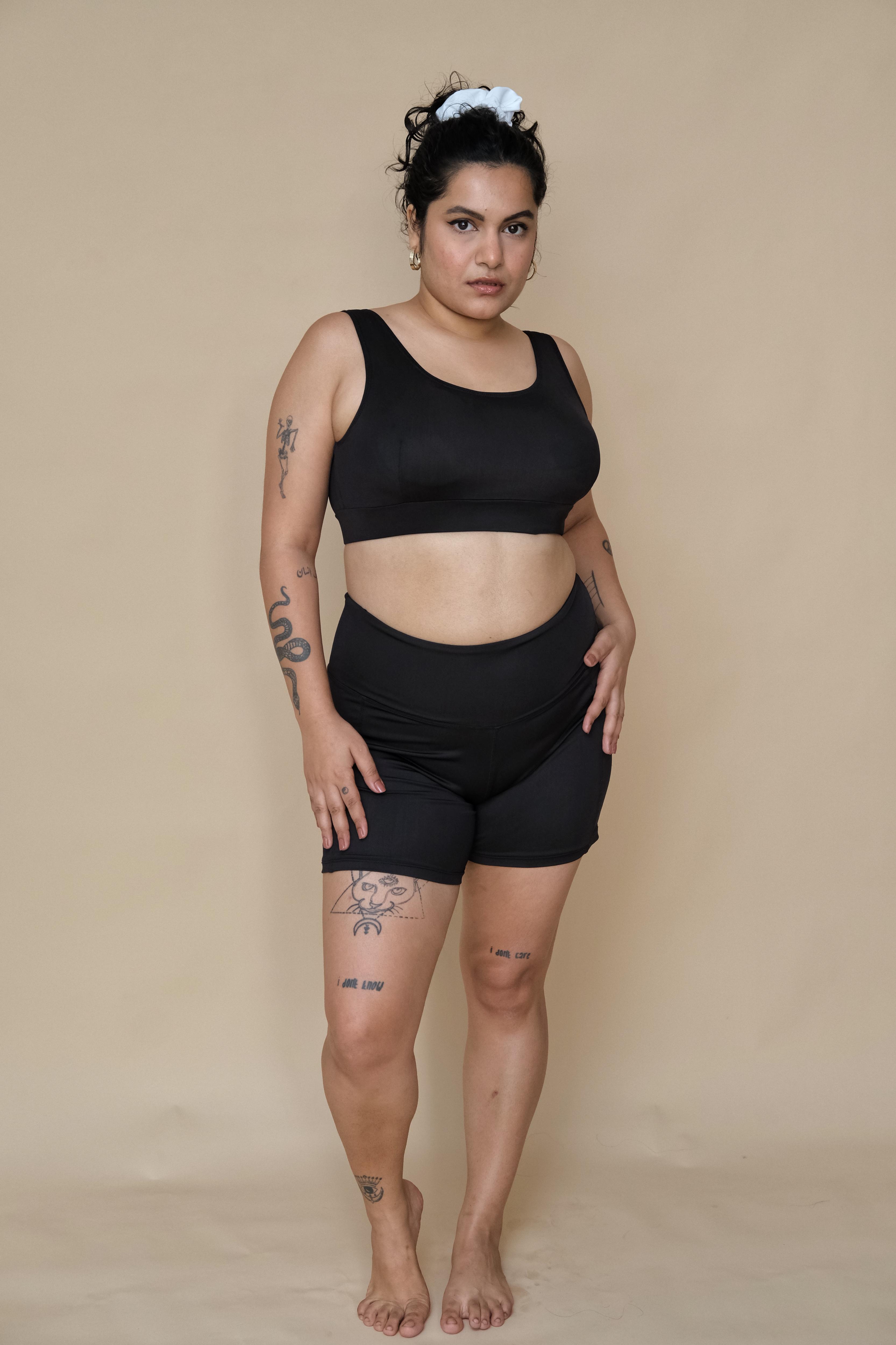 Woman wearing a black bikini top and shorts set 