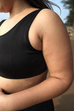 Plus size woman wearing a black round neck top