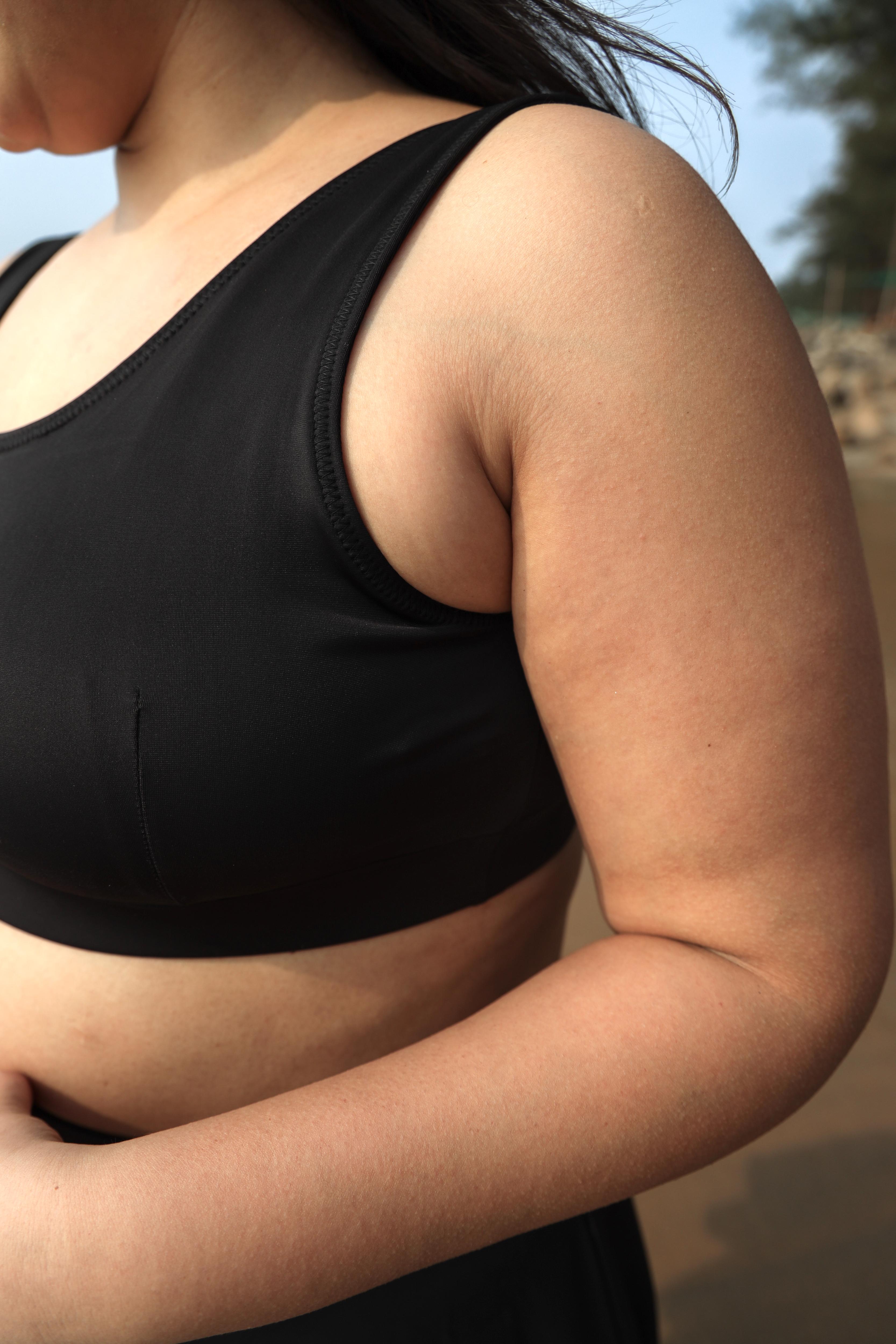 Plus size woman wearing a black round neck top