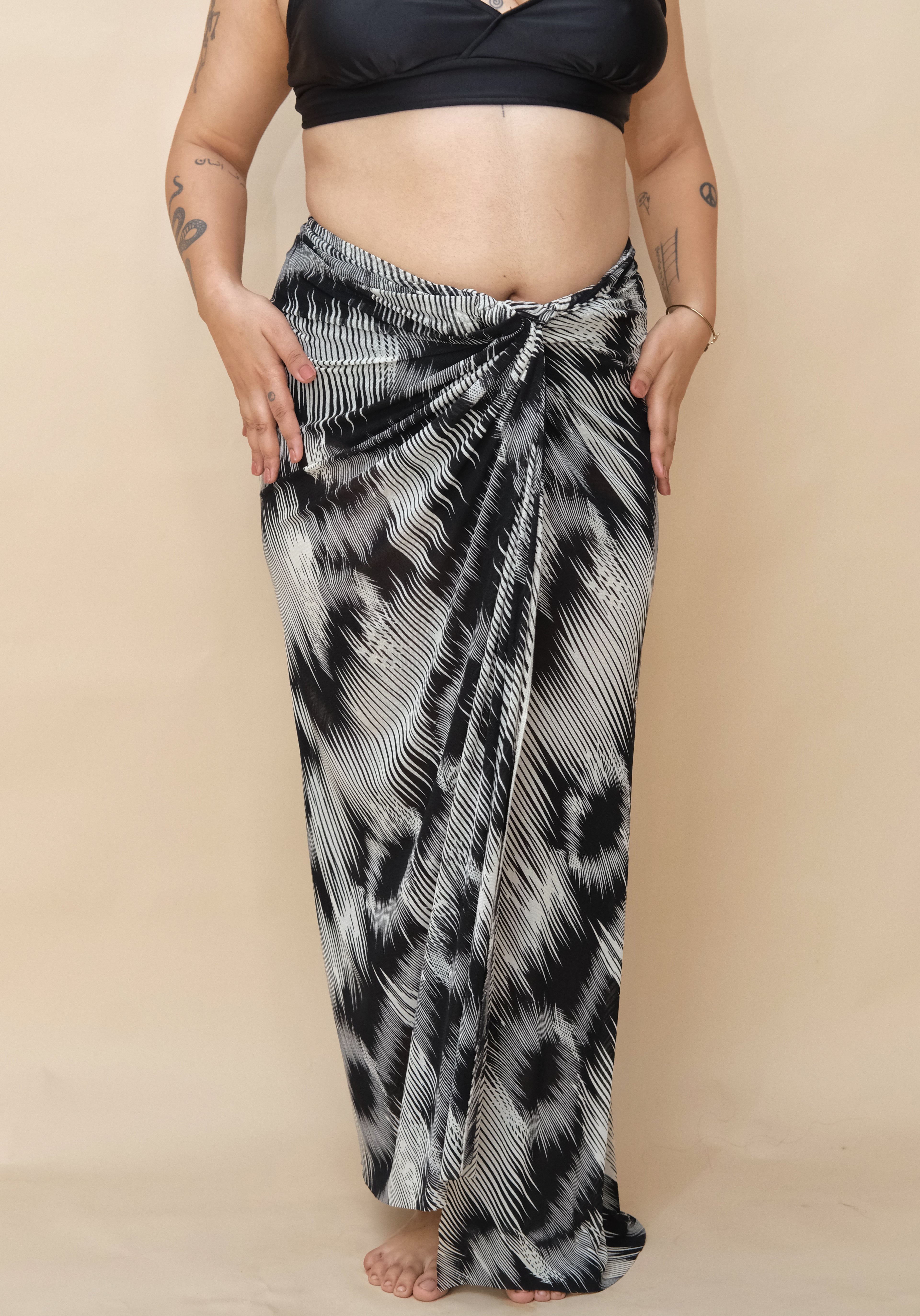 Woman wearing a black and white patterned sarong 