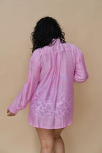Woman wearing a pink cow print shirt