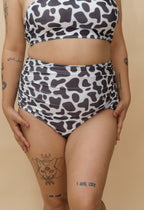 Woman wearing a cow print bikini set 