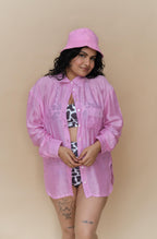 Woman wearing a pink shirt and matching pink cap