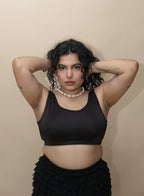 Woman wearing a black top and black skirt 