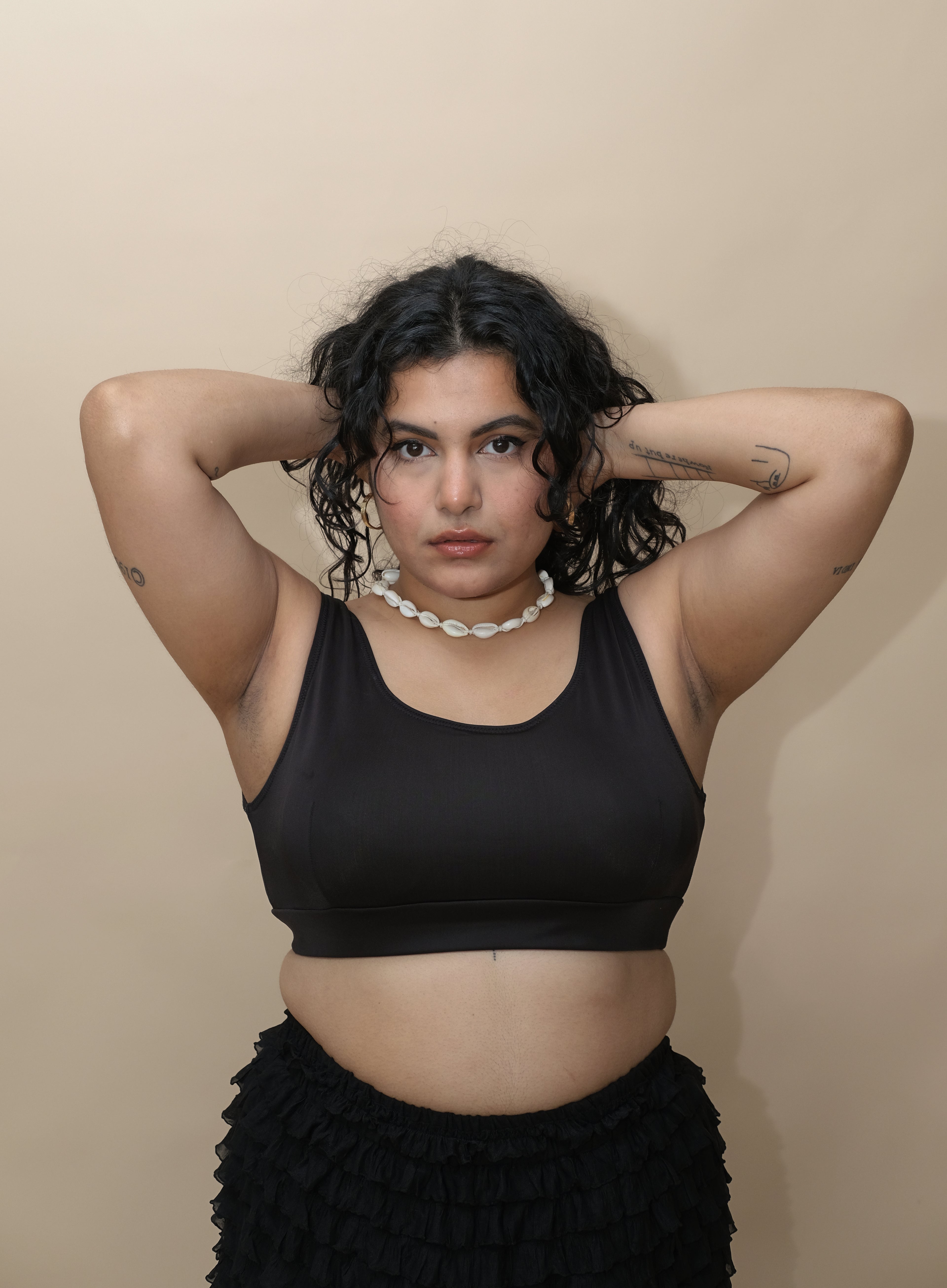 Woman wearing a black top and black skirt 