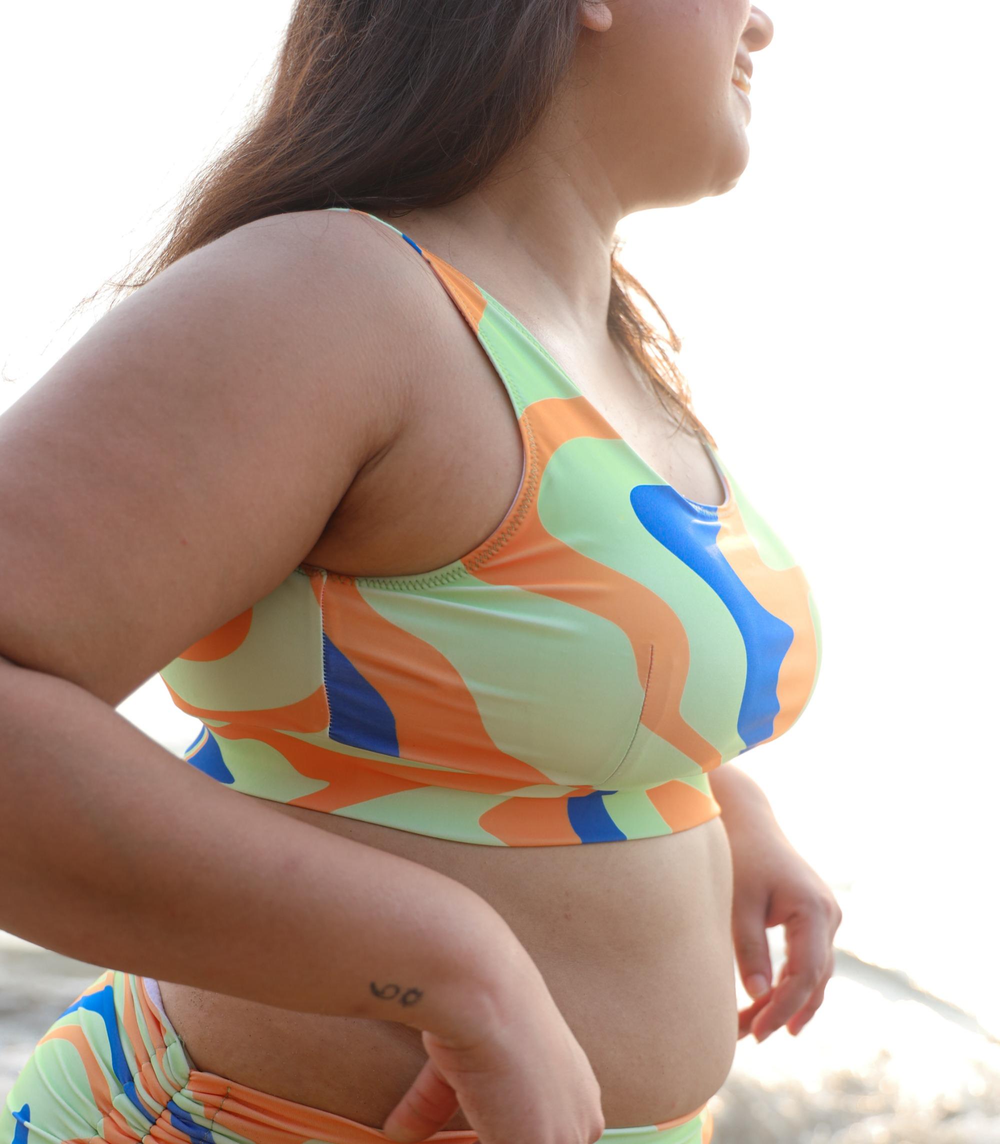 Asian woman wearing colorful swimsuit with abstract print