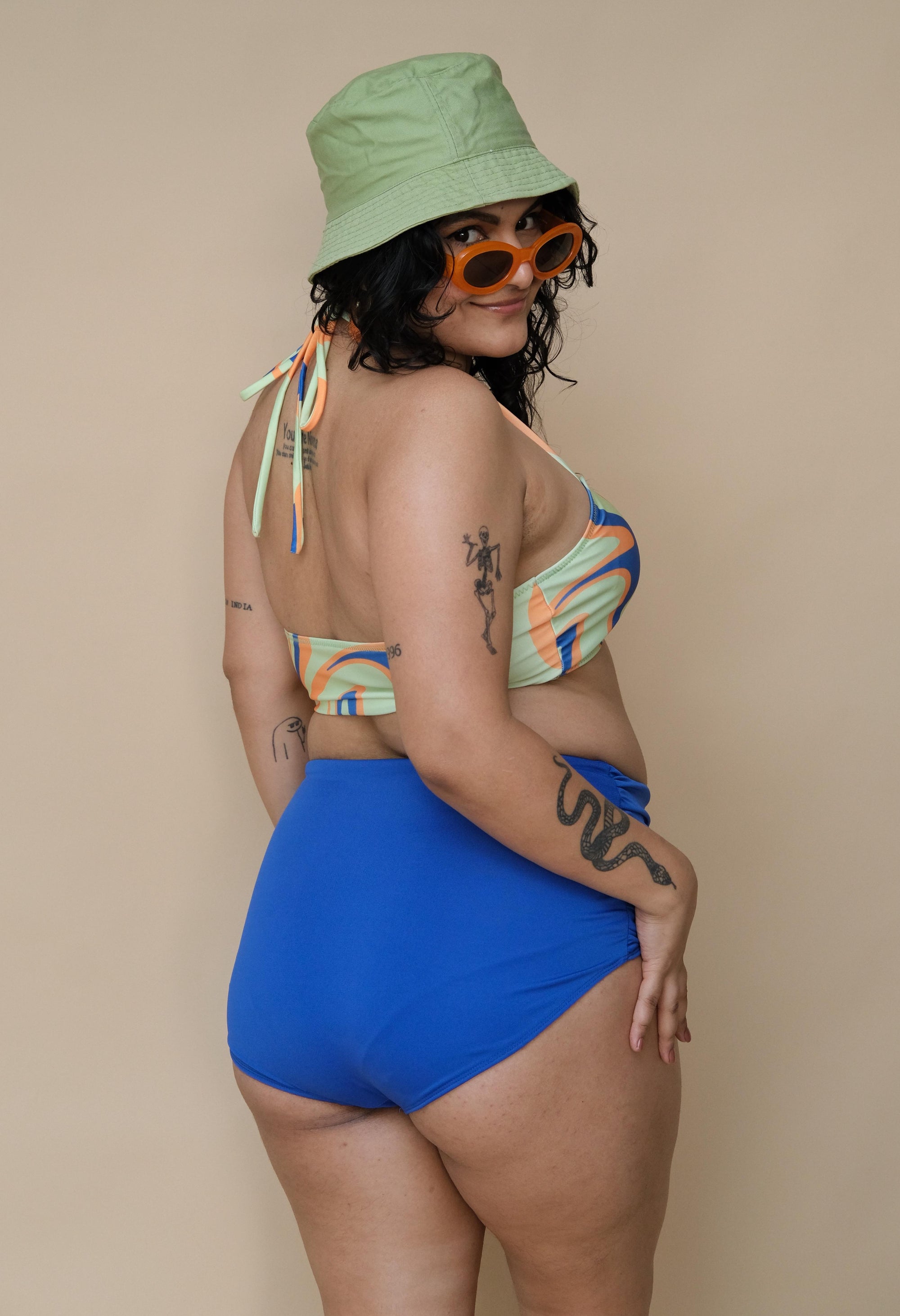 Woman wearing a colorful bikini top with blue bottom
