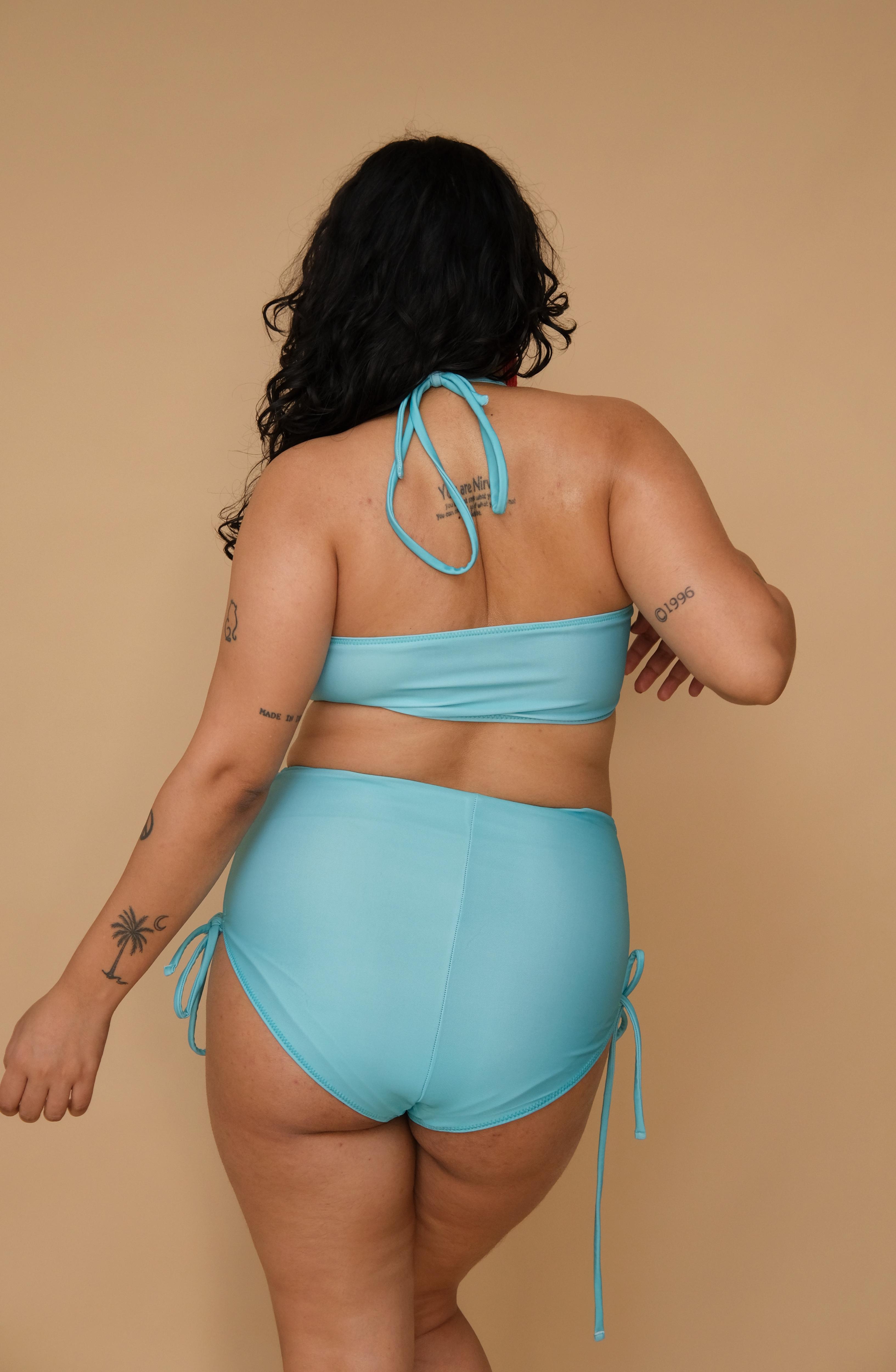 Plus size woman wearing a light blue bikini set