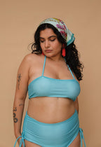 Woman wearing a blue bikini and colorful headscarf 