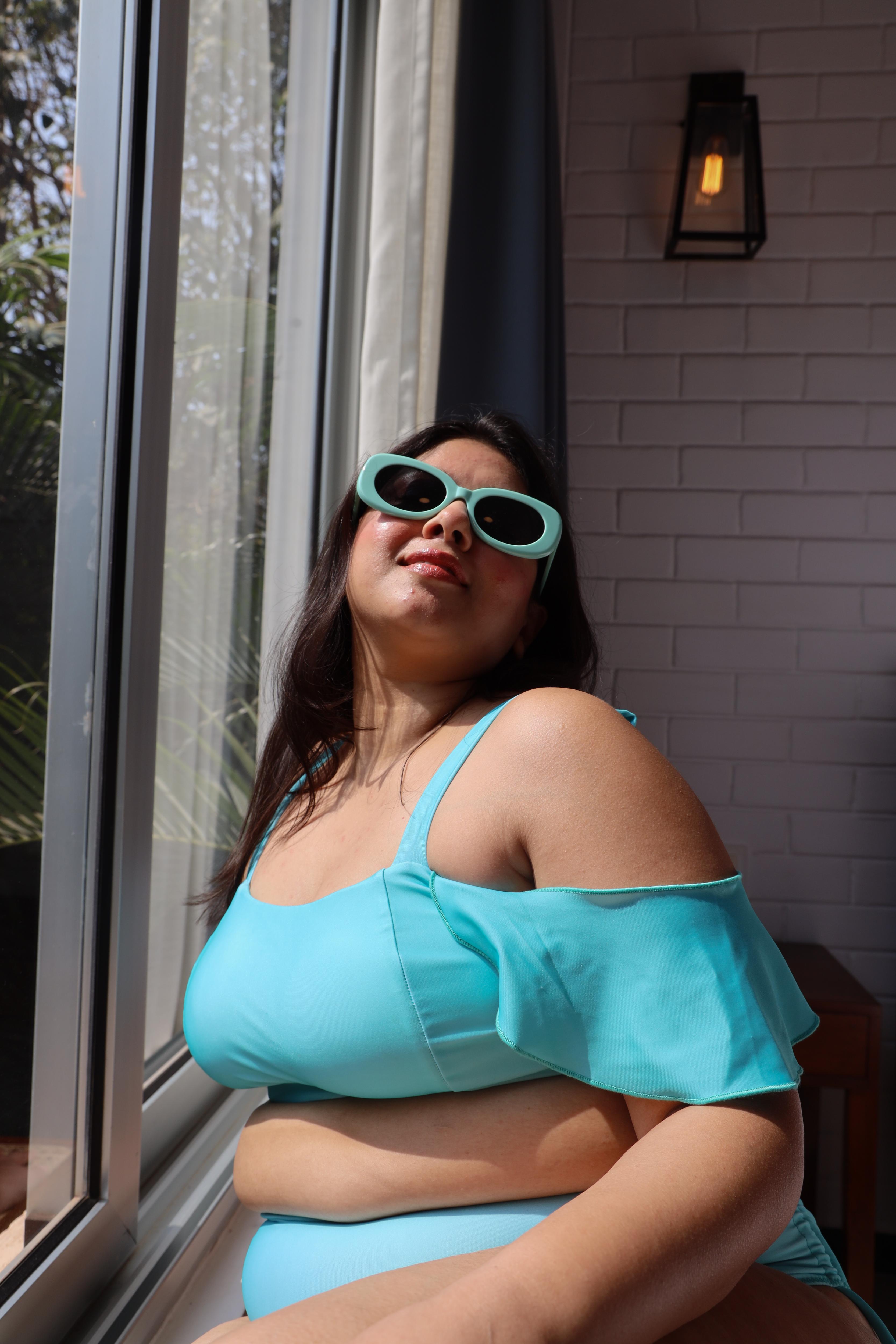 Asian woman wearing a blue bikini top