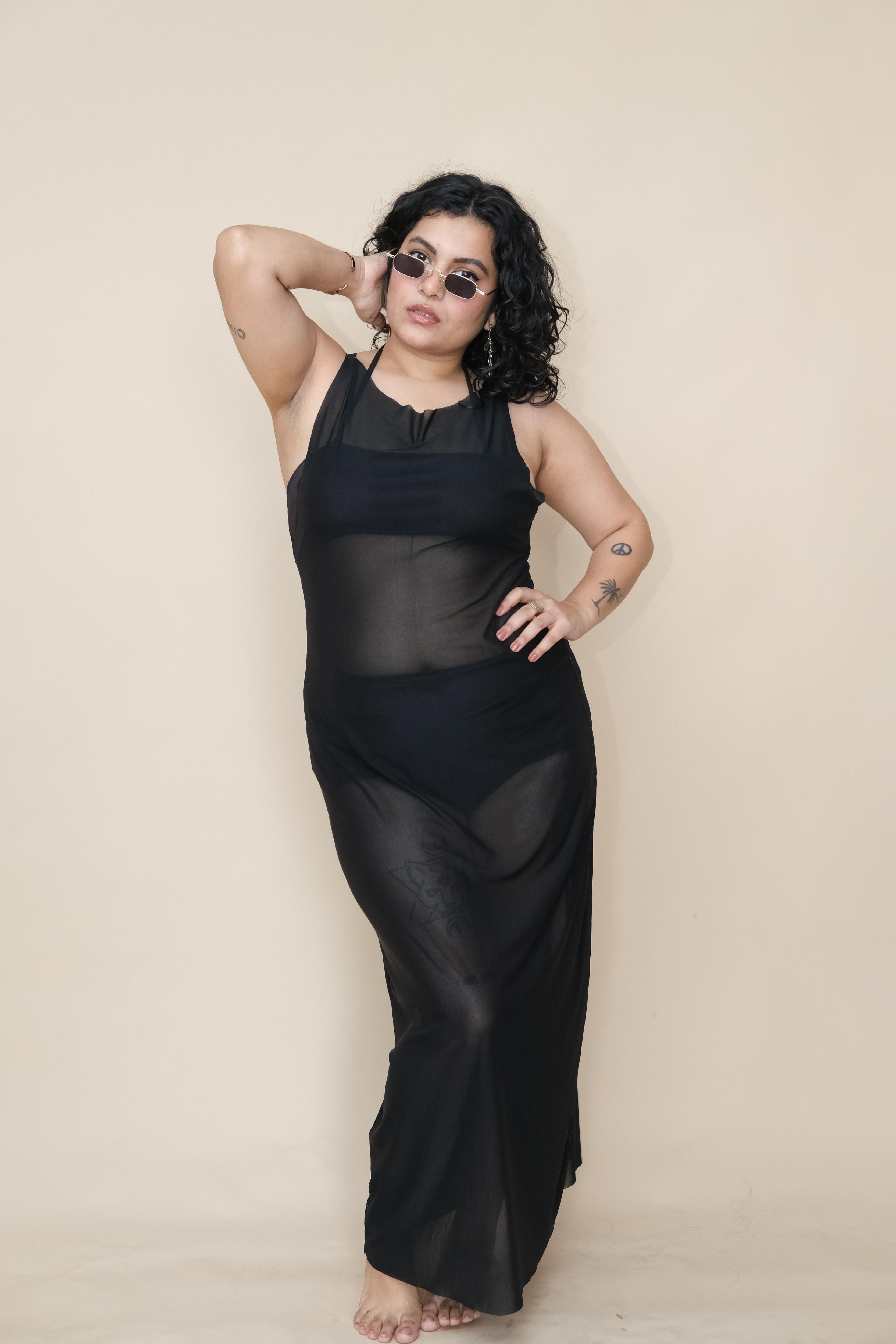 Plus size woman wearing a black sheer dress 