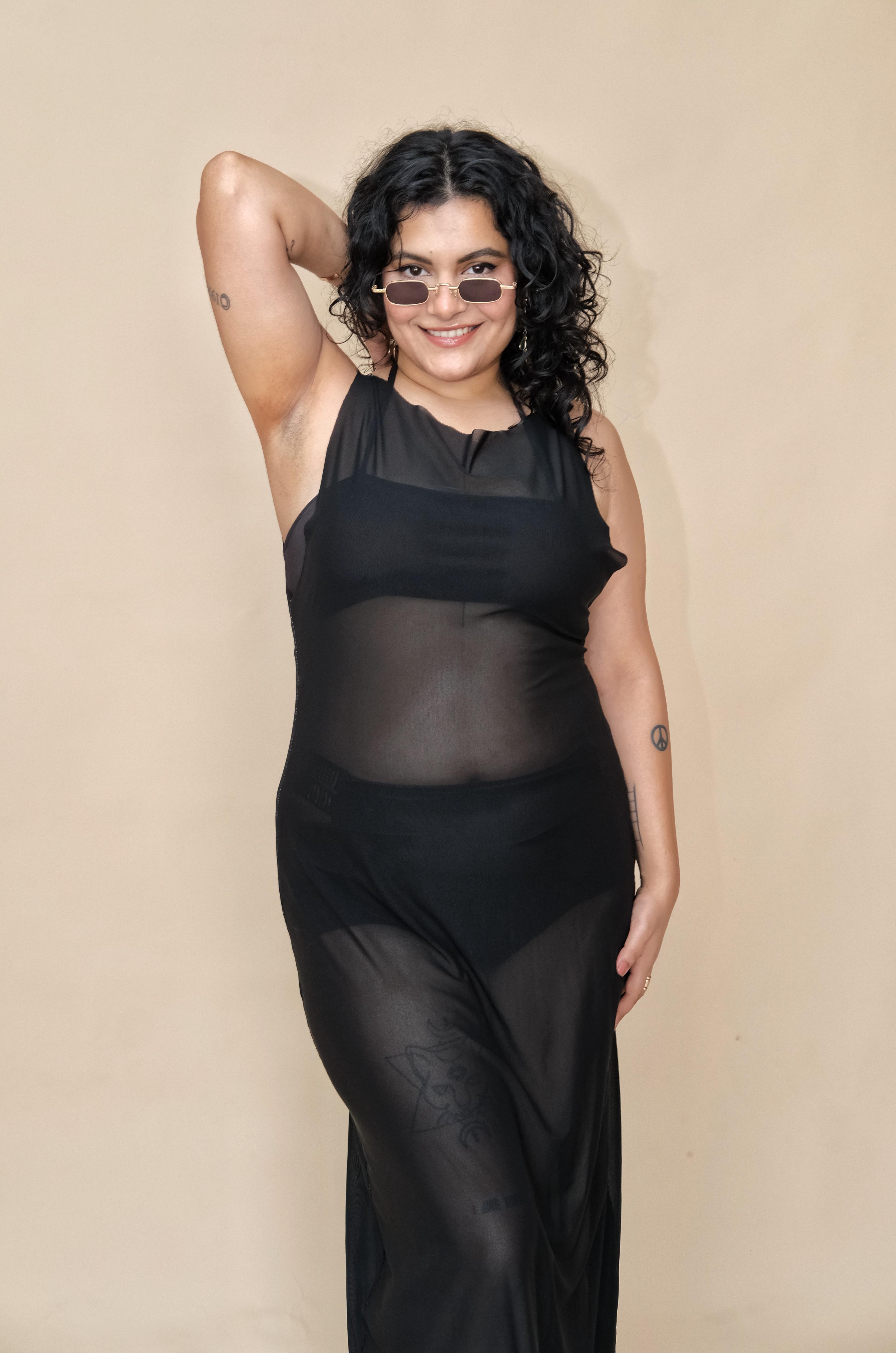 Plus size woman wearing a black outfit with sheer coverup