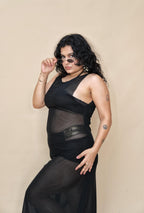 Woman wearing a black dress with sheer panels 