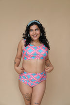 Woman wearing a pink and blue patterned bikini set 