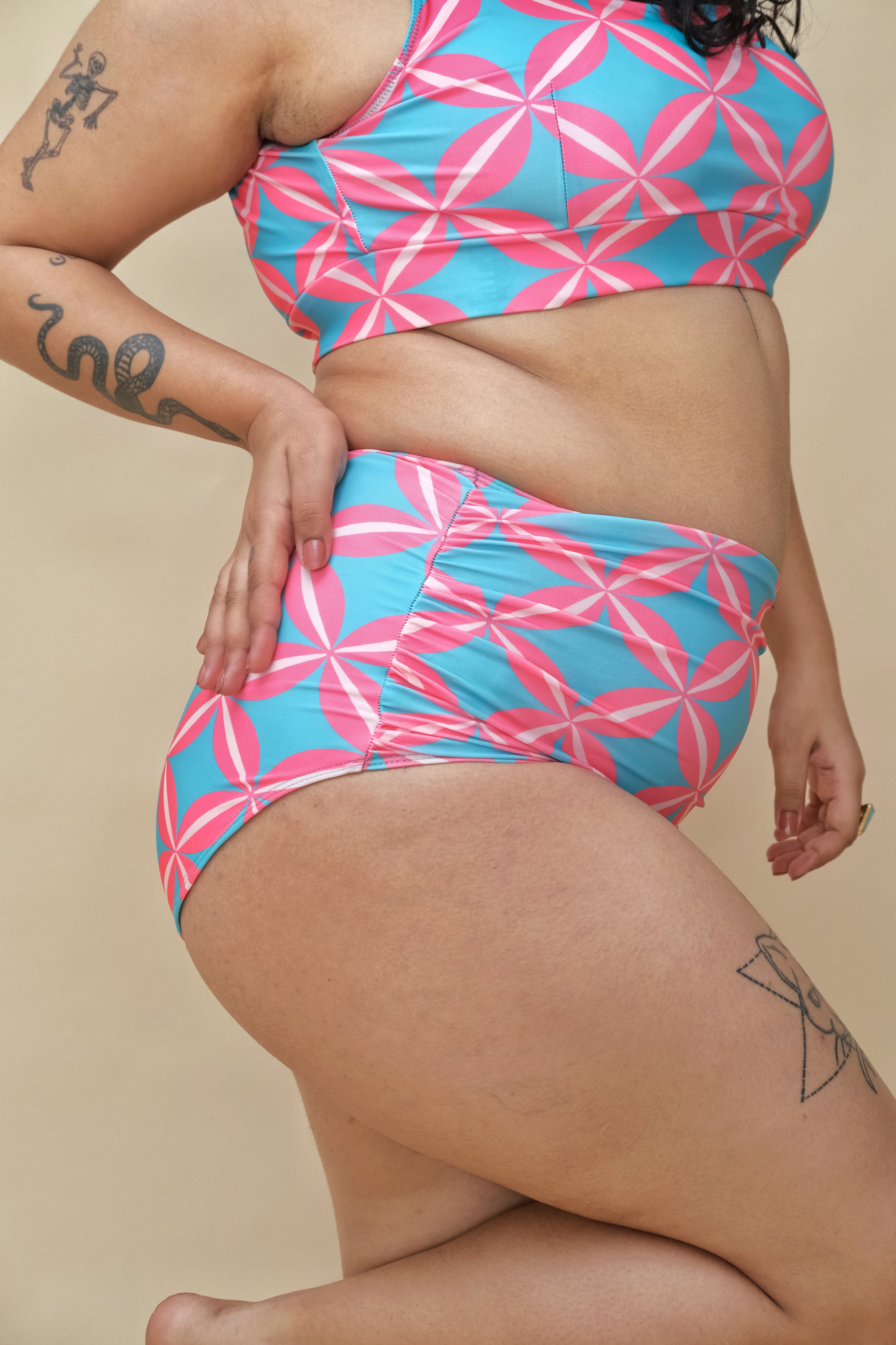 Woman wearing a pink and blue patterned two-piece swimsuit 