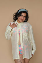 Woman wearing a sheer lime shirt over a colorful bikini set