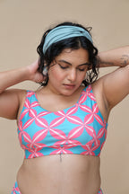 Woman wearing a blue and pink patterned top