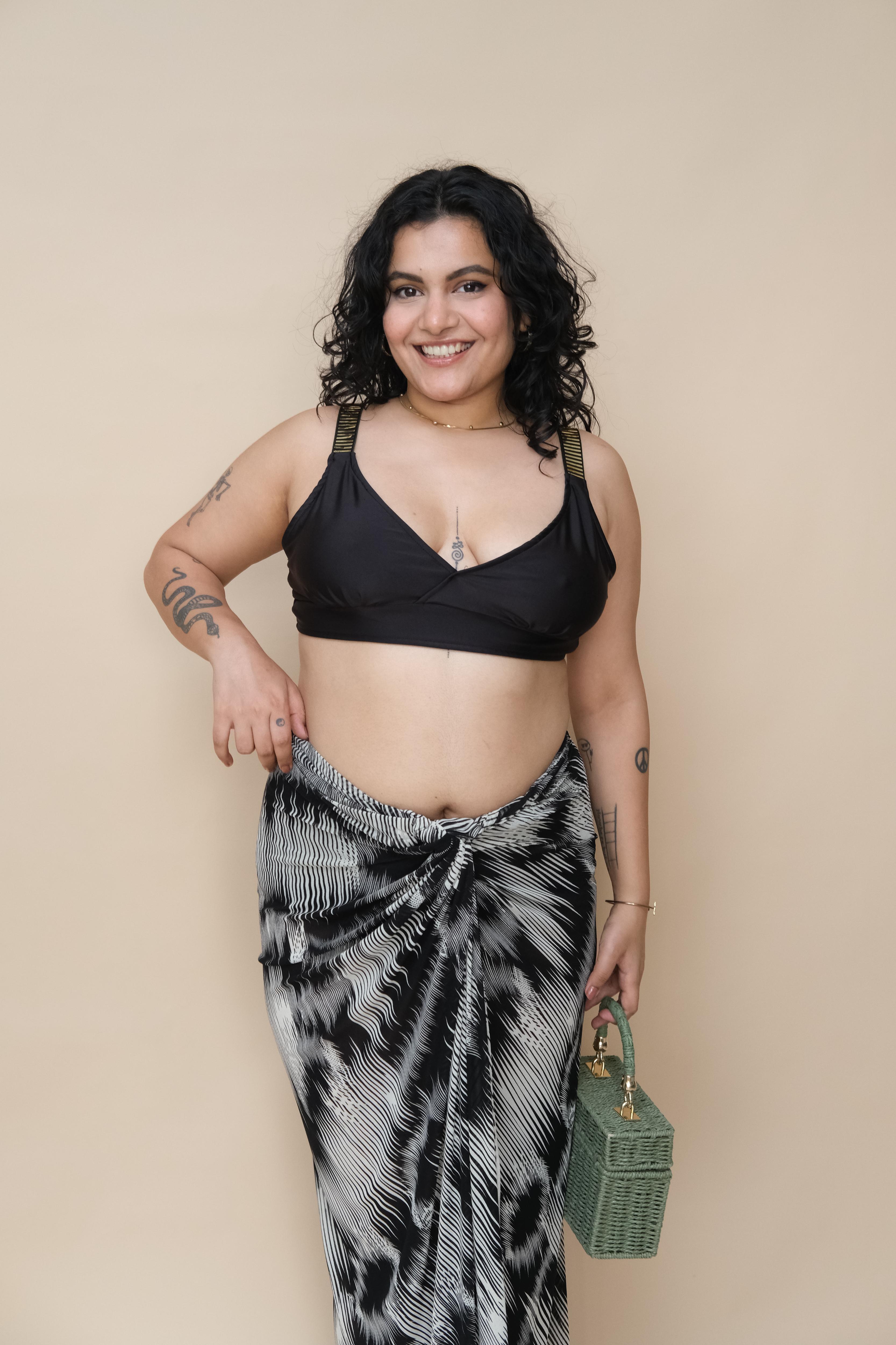 Woman wearing a black top and patterned skirt 