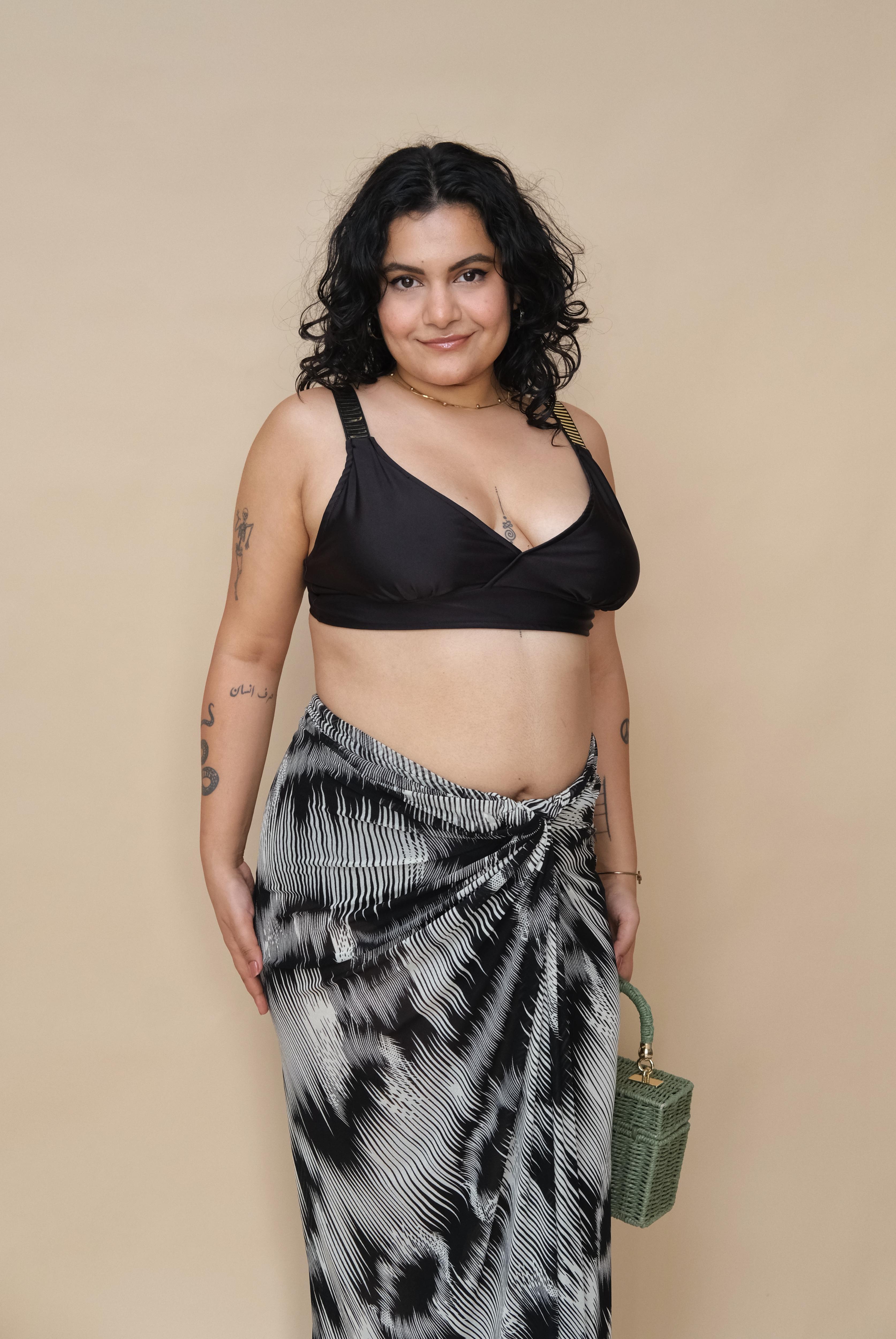 Woman wearing a black top and patterned skirt 