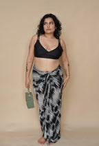 Woman wearing a black bikini top and patterned sarong 