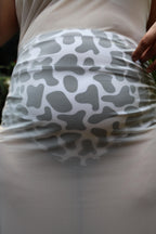 White skirt with gray pattern worn by a plus size woman