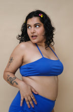 Woman wearing a blue bikini halter neck top