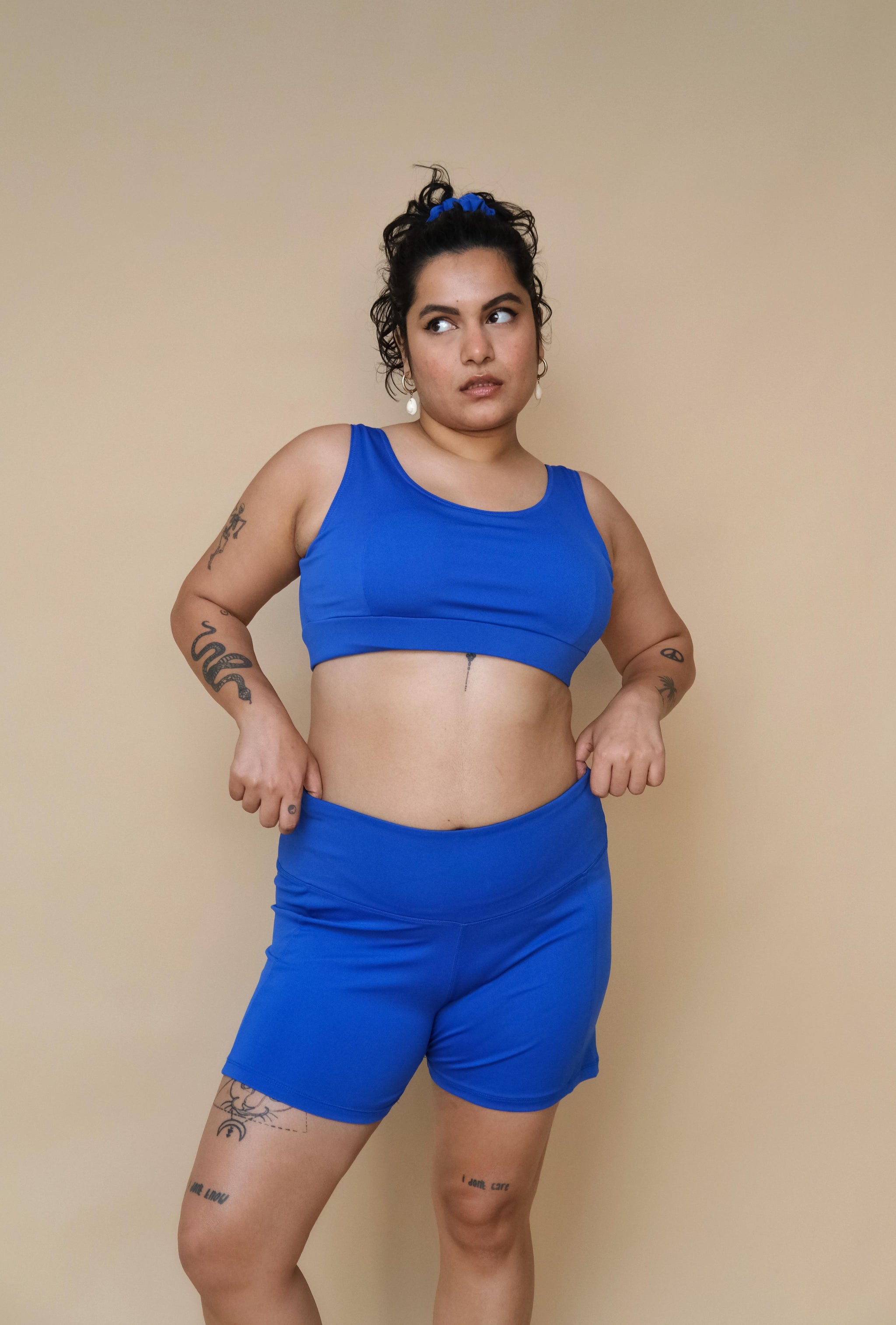 Woman wearing a blue top and shorts 