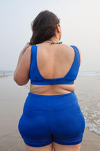 Curvy wearing a blue swimsuit