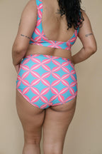 Woman wearing a pink and blue geometric patterned bikini set 