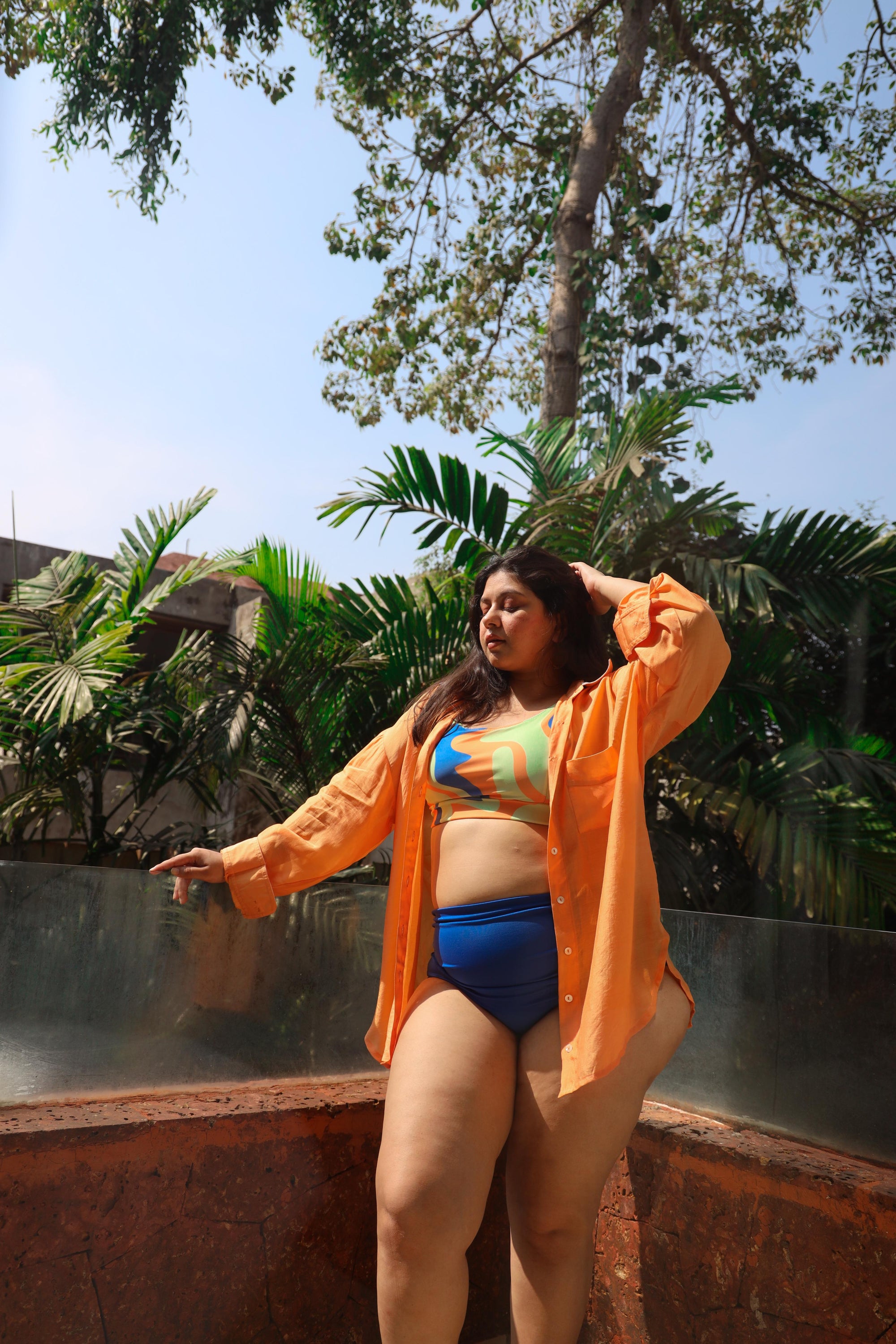 Woman in a blue bikini and orange cover-up 