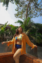 Woman in a colorful bikini and orange cover-up 
