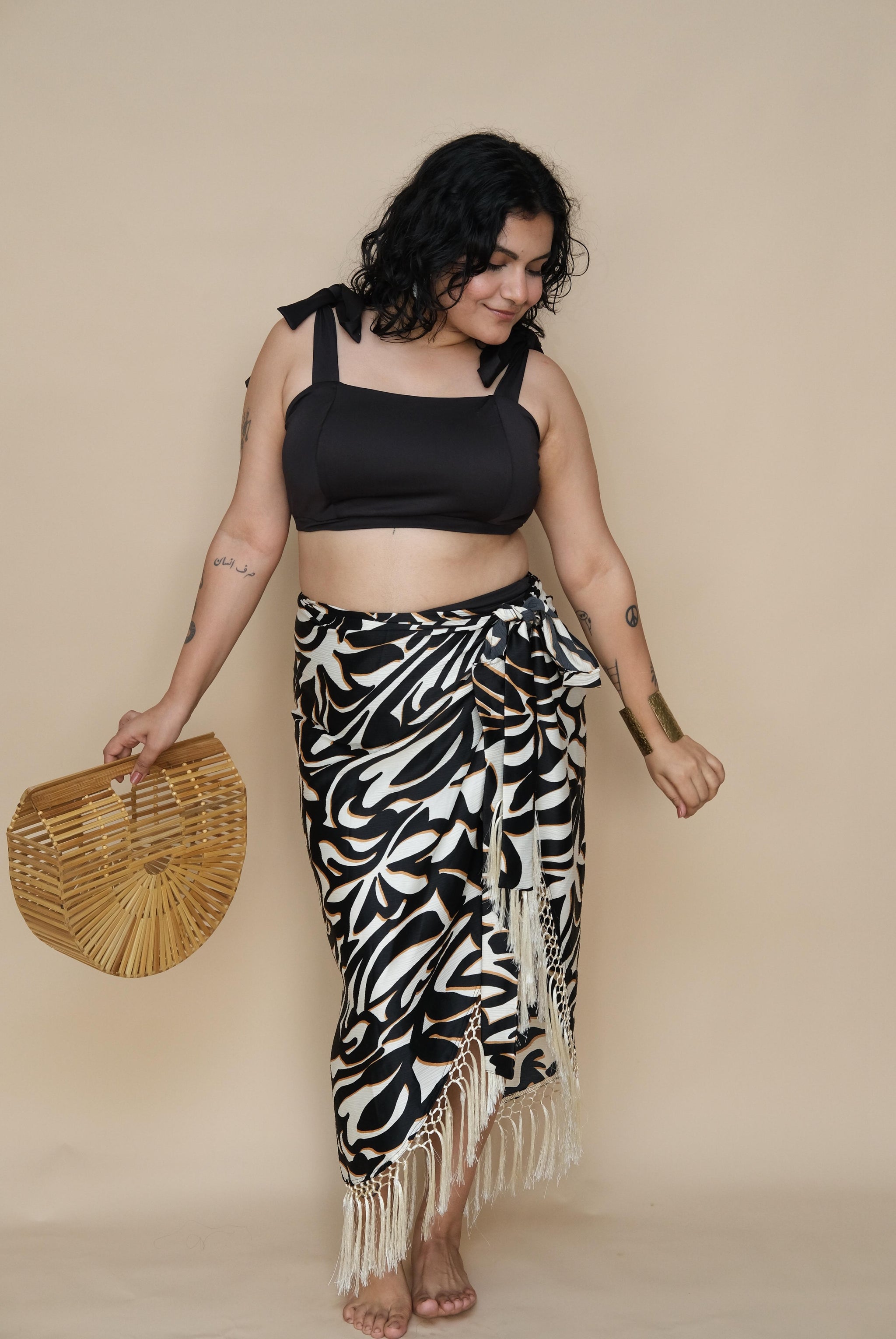 Woman wearing a black top and zebra print skirt 