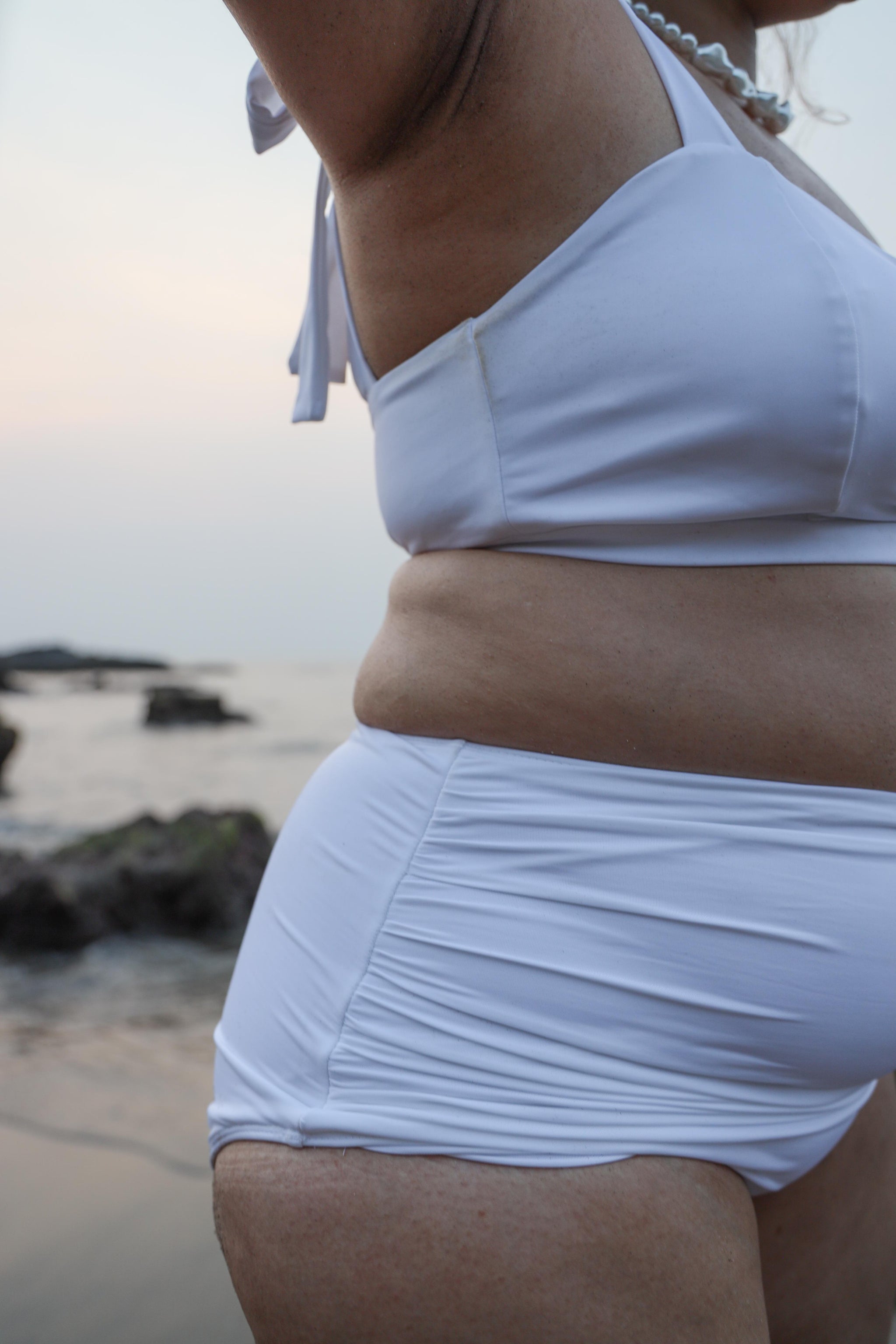 Plus size woman wearing a white bikini 