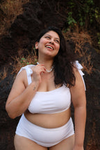 Plus size woman wearing a white bikini set