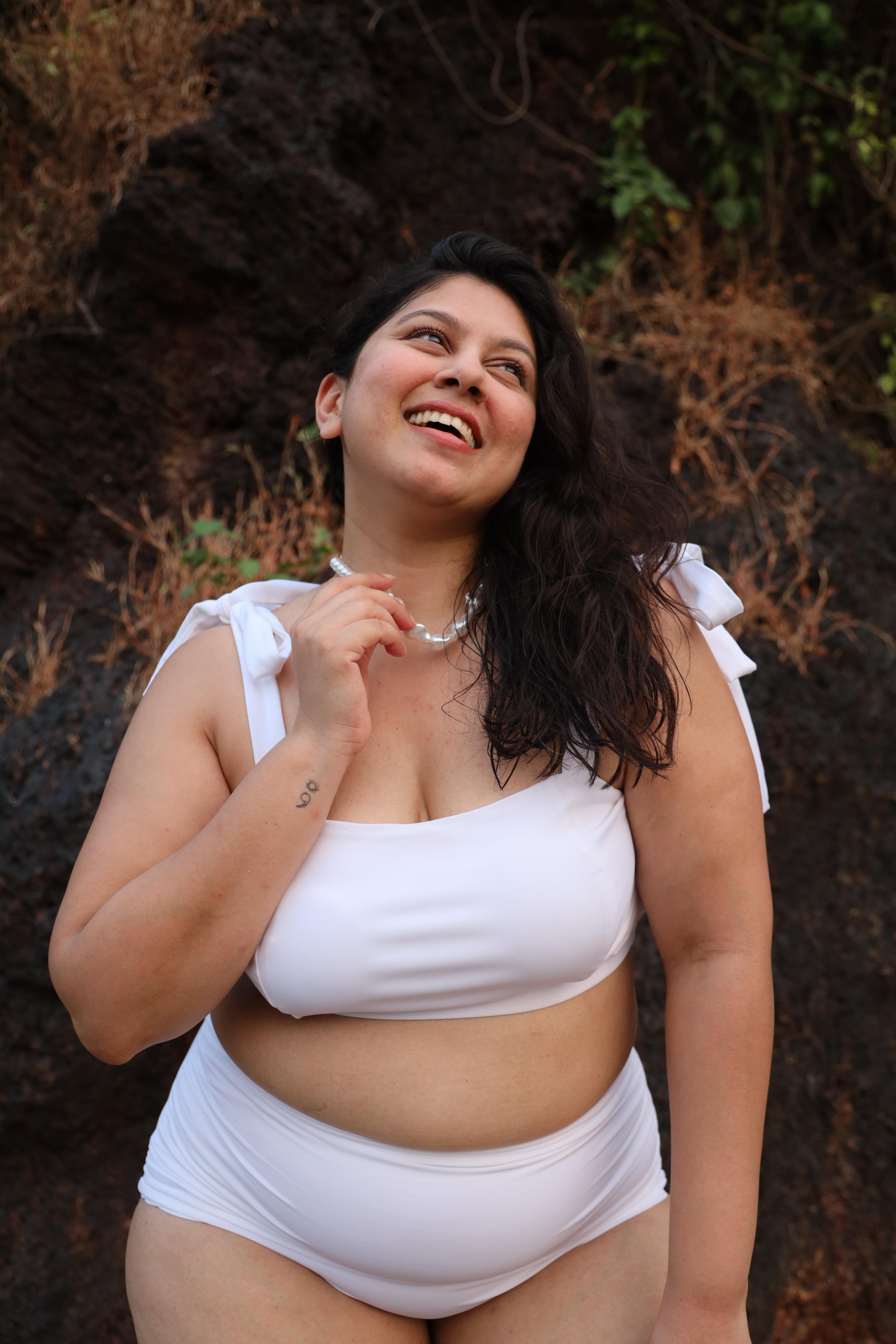 Plus size woman wearing a white bikini set