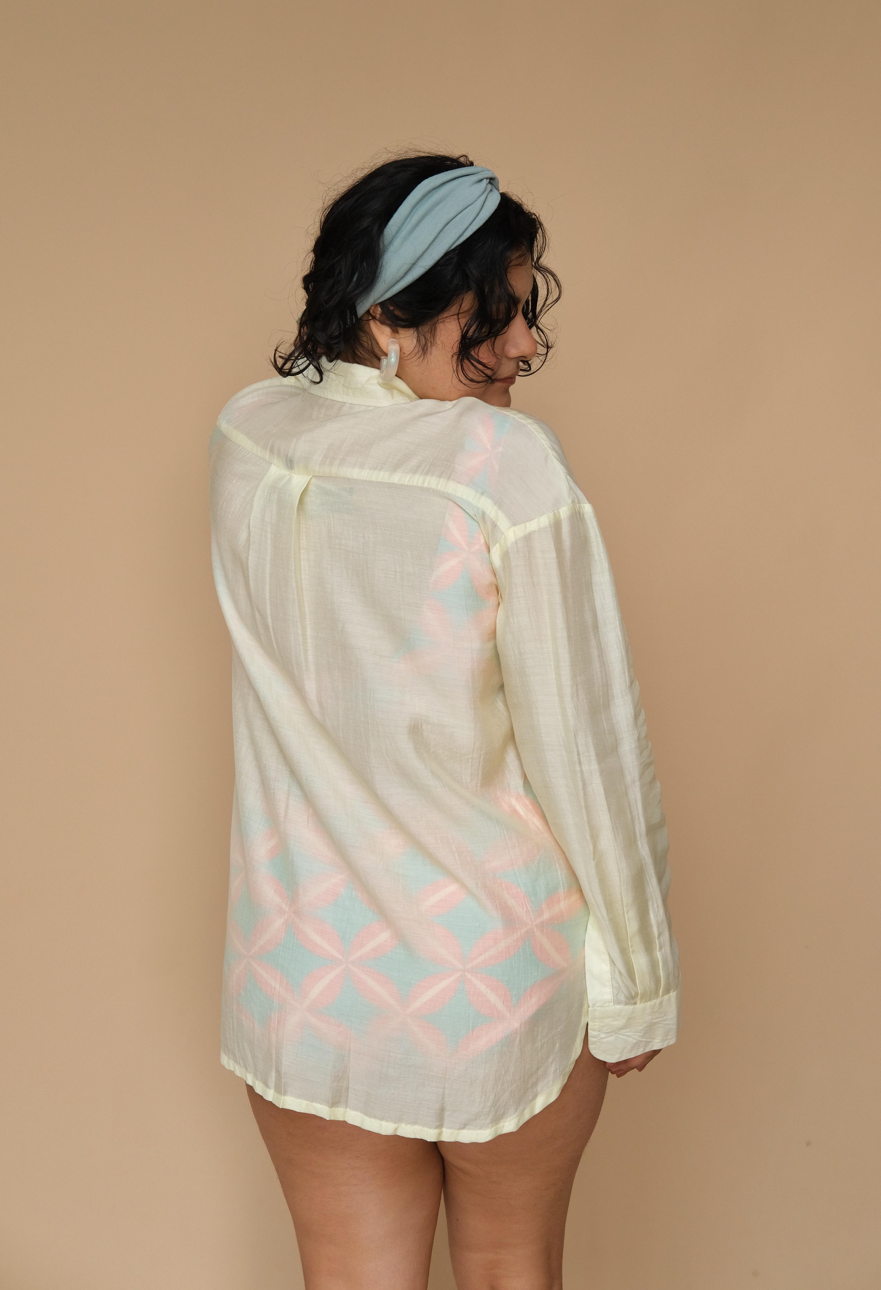 Woman wearing a sheer lime shirt with geometric patterns 